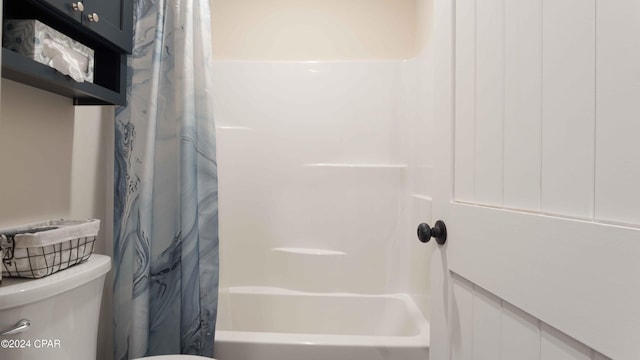 bathroom with toilet and shower / bath combo with shower curtain