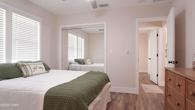 bedroom featuring hardwood / wood-style floors, a closet, and ceiling fan