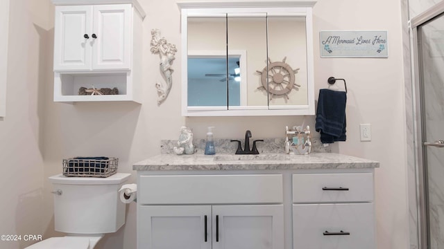 bathroom featuring vanity, ceiling fan, and toilet