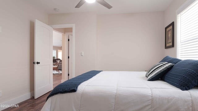 bedroom with ceiling fan and dark wood-type flooring