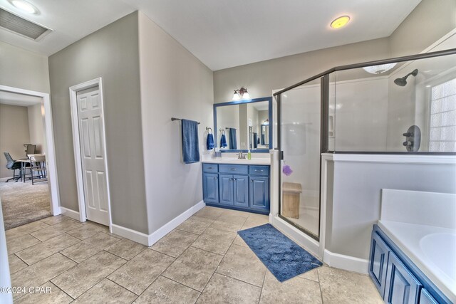 bathroom with tile patterned floors, vanity, and separate shower and tub