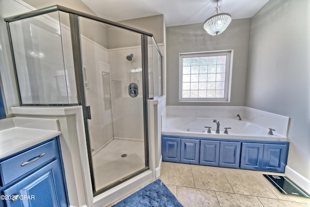 bathroom featuring a stall shower, tile patterned flooring, and a garden tub