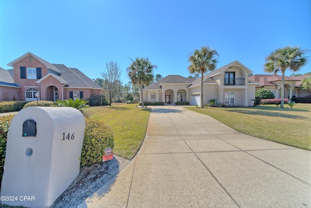 view of front facade featuring a garage and a front lawn