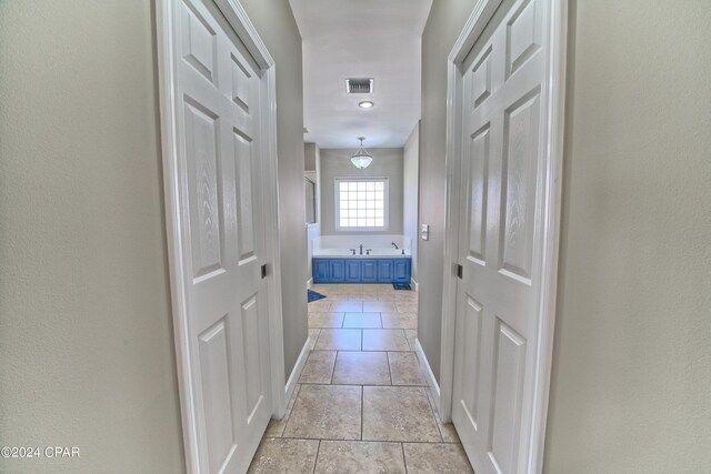 hallway featuring light tile patterned flooring