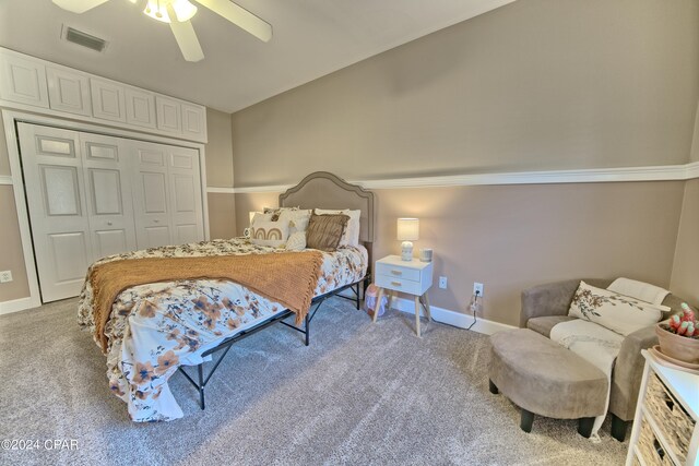 carpeted bedroom featuring ceiling fan and a closet