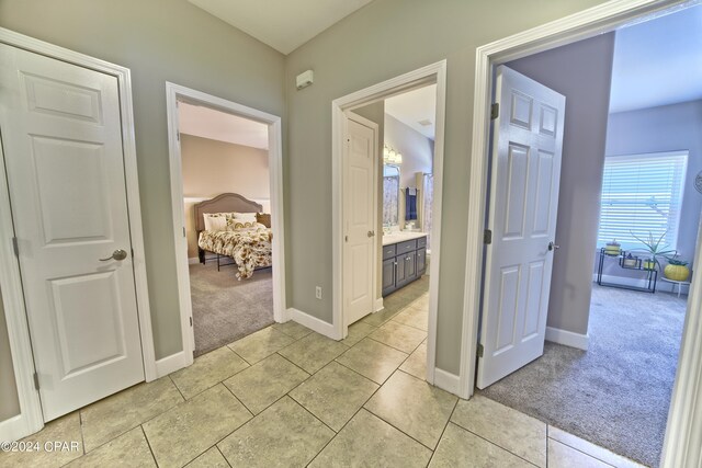 hall featuring light tile patterned floors