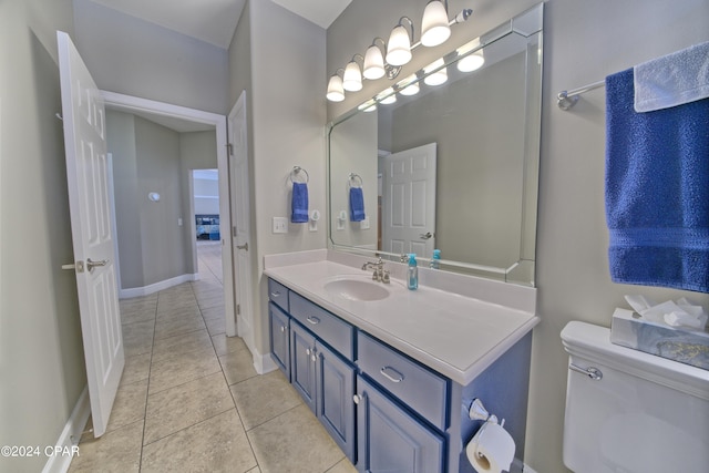 bathroom featuring vanity, toilet, and tile patterned flooring