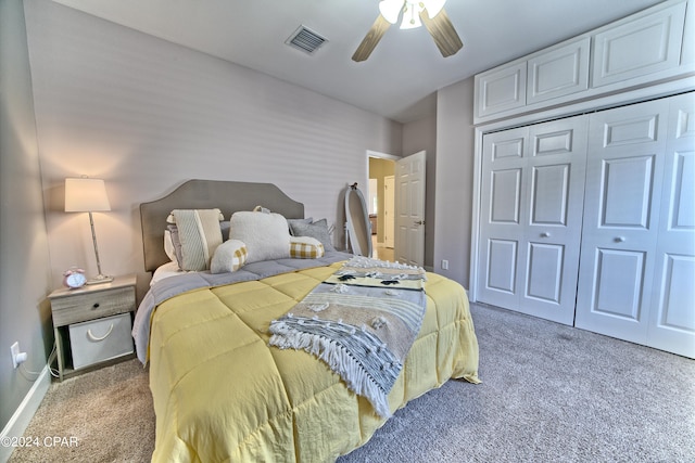 carpeted bedroom featuring a closet and ceiling fan