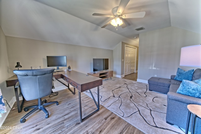 office area with baseboards, visible vents, a ceiling fan, lofted ceiling, and wood finished floors