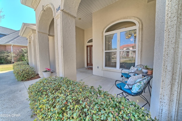 property entrance with stucco siding