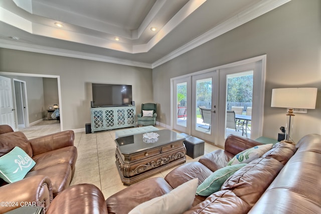 living room featuring french doors, a tray ceiling, light tile patterned floors, and crown molding