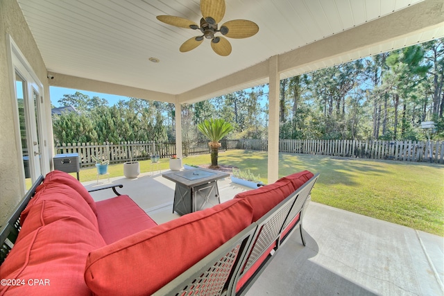 view of patio / terrace with an outdoor living space with a fire pit and ceiling fan