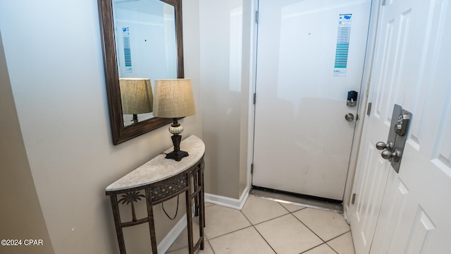 doorway to outside featuring light tile flooring