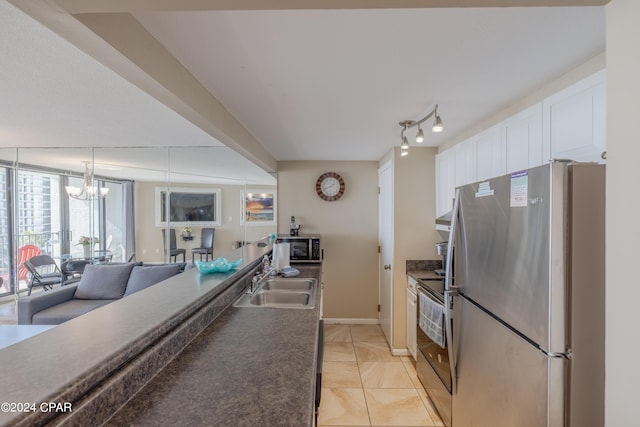 kitchen featuring light tile patterned floors, sink, pendant lighting, stainless steel appliances, and white cabinets