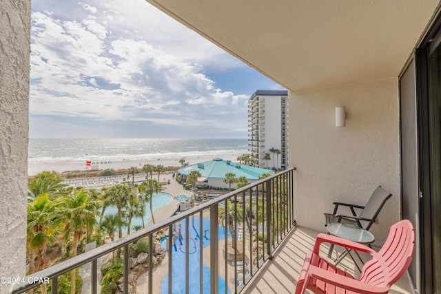 balcony with a beach view and a water view