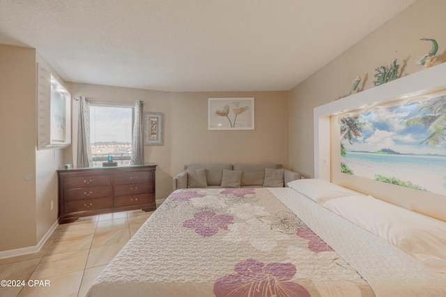 tiled bedroom featuring a textured ceiling