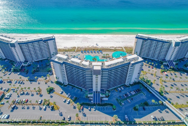 drone / aerial view featuring a water view and a view of the beach