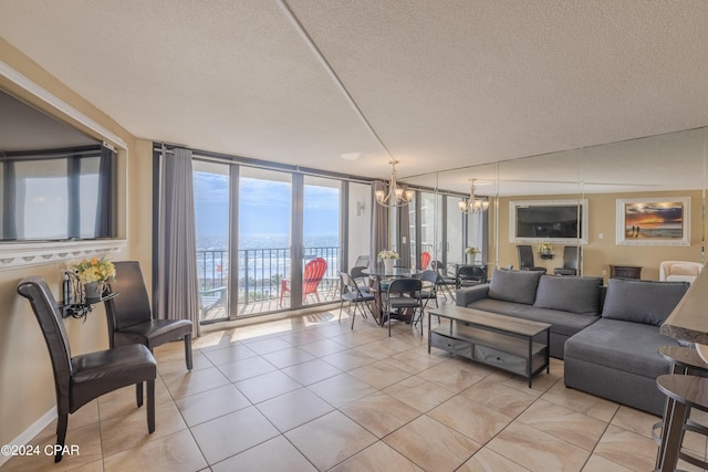 living room with a water view, a textured ceiling, a chandelier, floor to ceiling windows, and light tile patterned floors