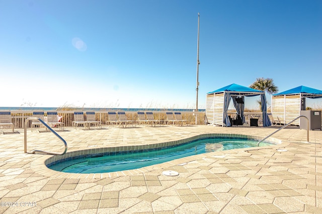 view of pool featuring a patio area and a hot tub