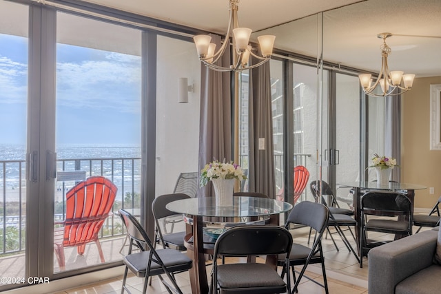 dining area with a water view, a chandelier, and floor to ceiling windows