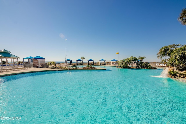 view of pool with pool water feature and a gazebo