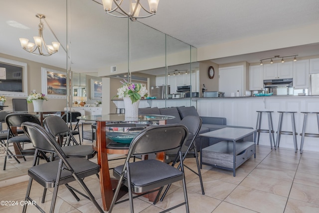 dining room featuring light tile patterned flooring and an inviting chandelier