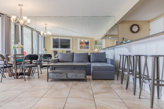 living room featuring light tile patterned flooring, a textured ceiling, and a notable chandelier