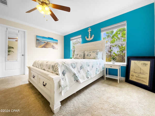 bedroom with light colored carpet, ceiling fan, ornamental molding, and multiple windows