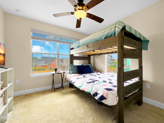 bedroom with ceiling fan and light carpet