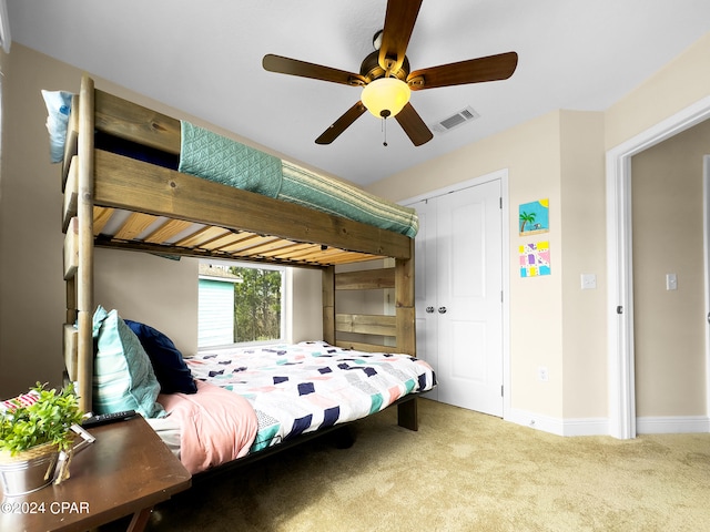 bedroom featuring a closet, light carpet, and ceiling fan