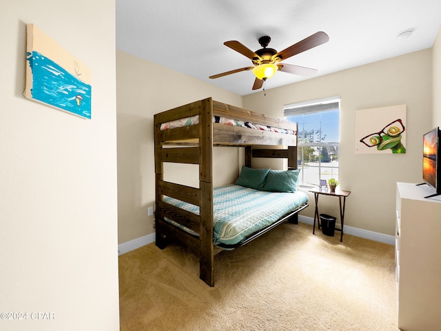 bedroom with light carpet and ceiling fan