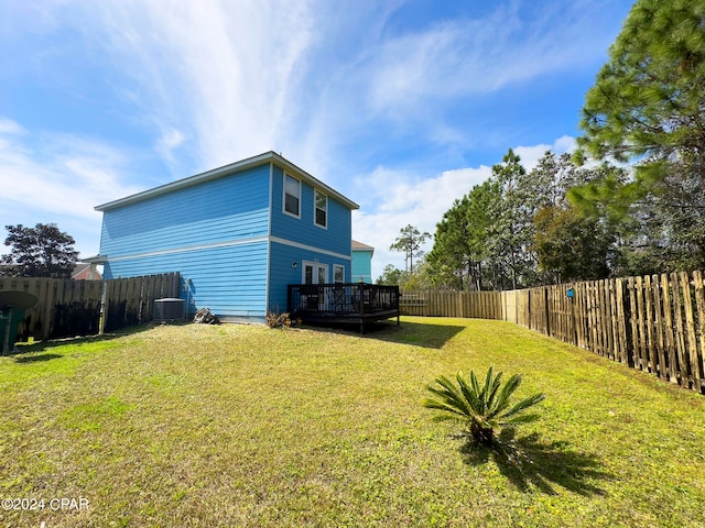 view of yard featuring a deck and central air condition unit