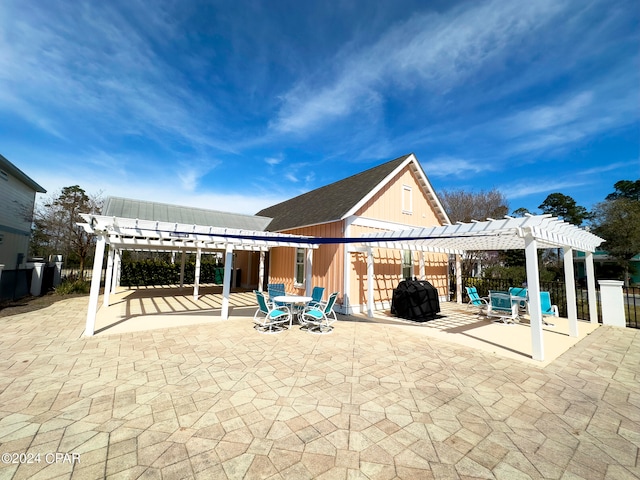 back of property with a pergola and a patio