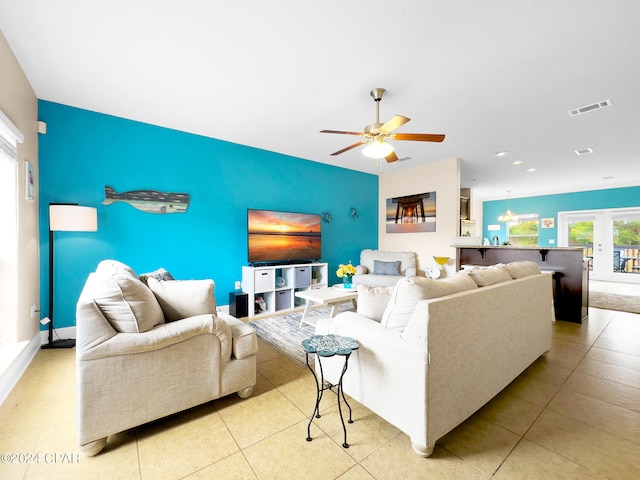 living room with ceiling fan and light tile floors