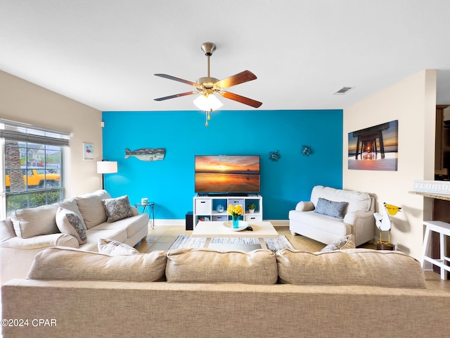 tiled living room featuring ceiling fan