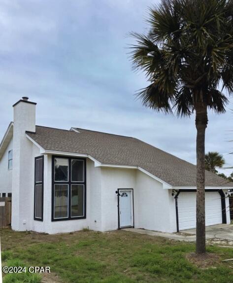 view of front of home with a garage and a front yard