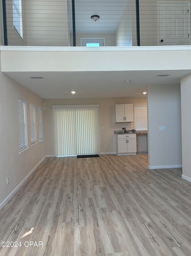 unfurnished living room featuring light hardwood / wood-style floors