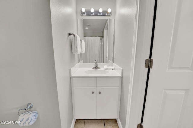 bathroom featuring vanity with extensive cabinet space and tile flooring