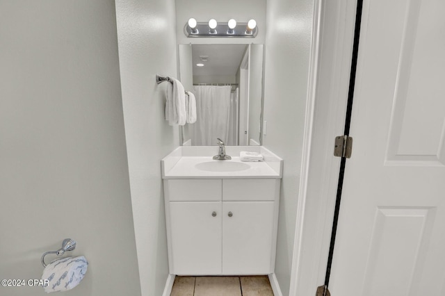 bathroom featuring a shower with shower curtain, vanity, and tile patterned flooring