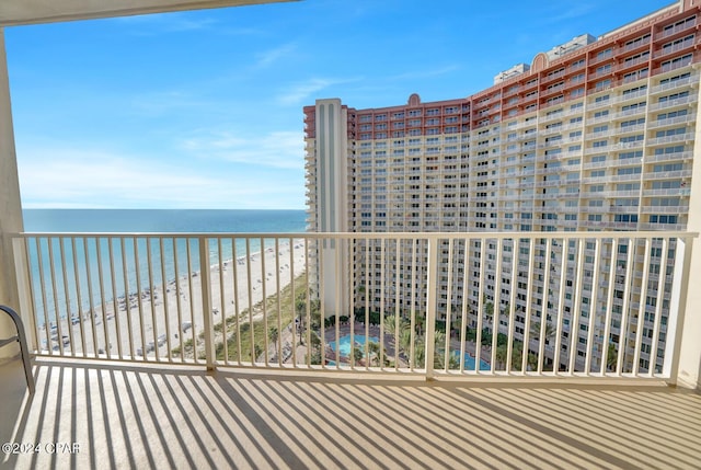 balcony featuring a water view and a view of the beach