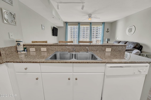 kitchen featuring white cabinetry, sink, white dishwasher, and kitchen peninsula