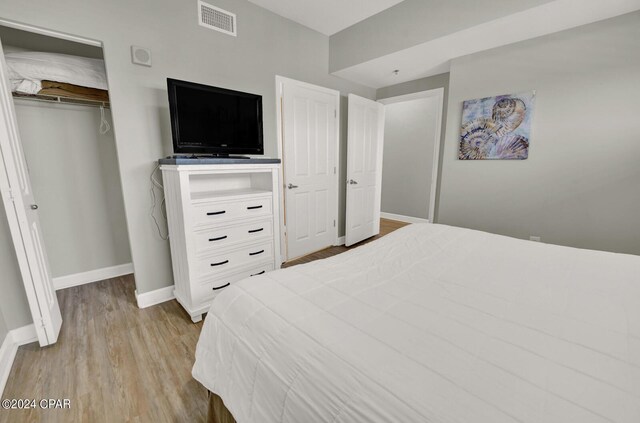 bedroom with a closet and light wood-type flooring