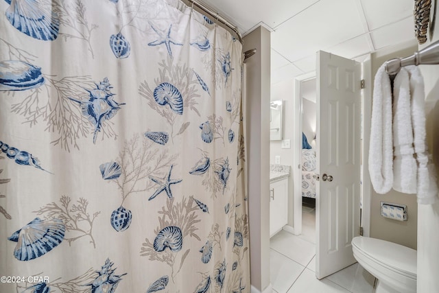 bathroom with tile flooring, vanity, and toilet