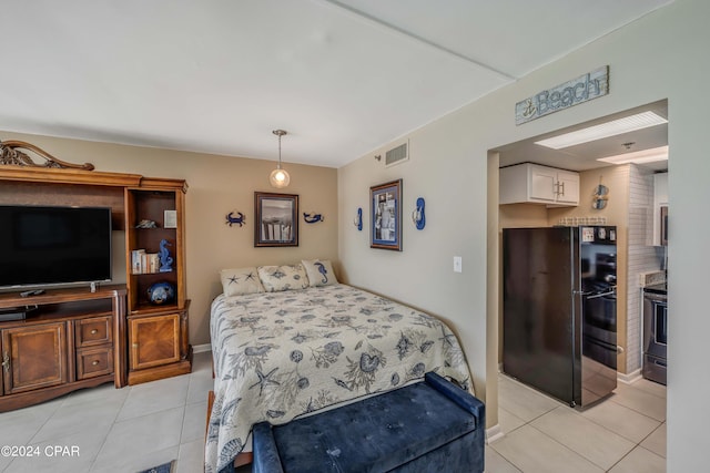 bedroom with black refrigerator and light tile floors