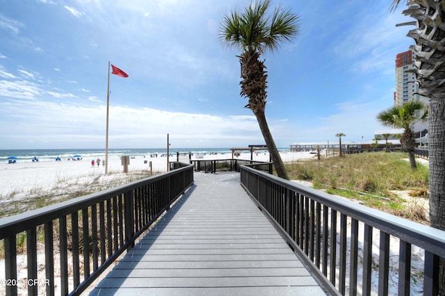 surrounding community featuring a water view and a view of the beach