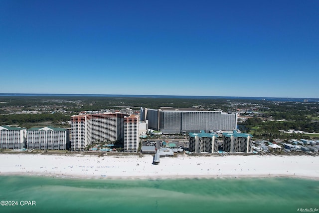 drone / aerial view with a water view and a beach view