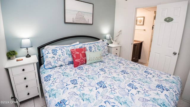 tiled bedroom featuring ensuite bathroom