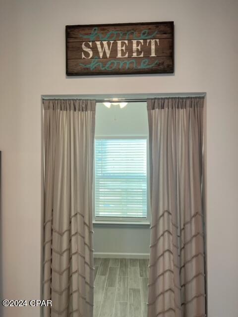 bathroom with wood finished floors and baseboards