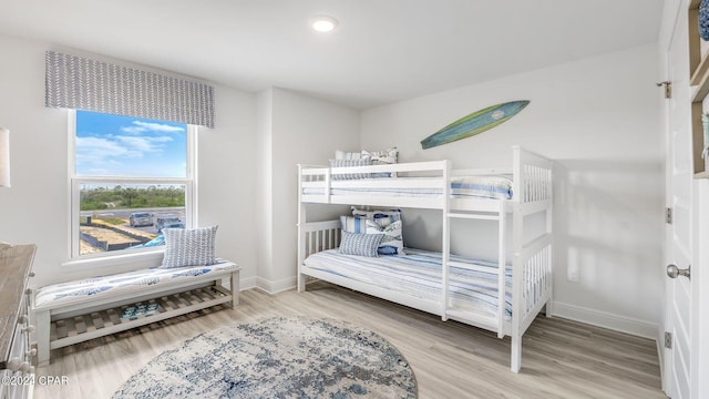 bedroom with baseboards and wood finished floors