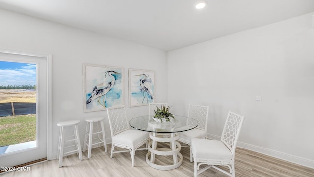 dining room with baseboards and wood finished floors